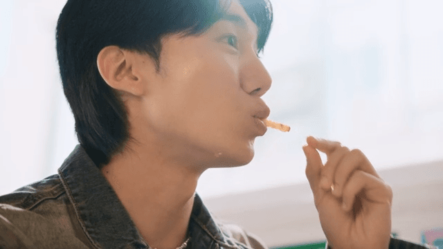 Young man enjoying a meal indoors
