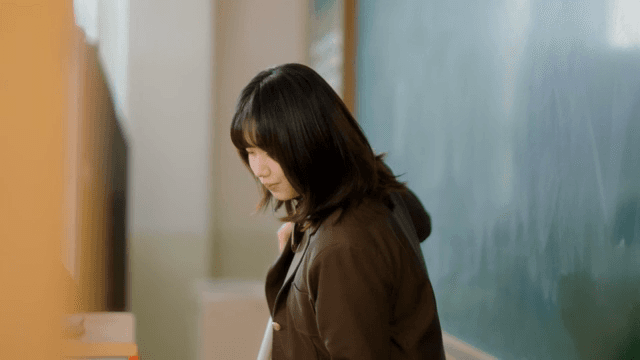 Student cleaning a classroom