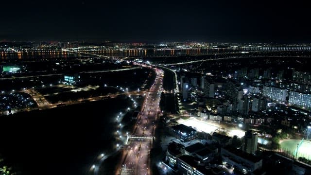 Night View Illuminated by the Lights of Buildings and Traffic in a Bustling City