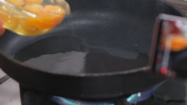 Stirring Eggs in a Hot Frying Pan on a Stove