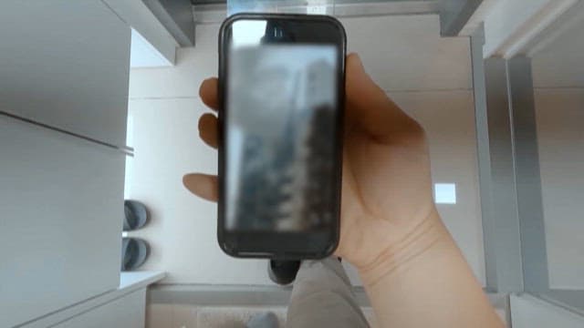 Person Watching a Fire Through a Smartphone