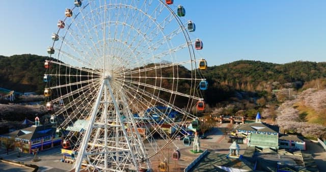 View of a colorful Ferris wheel and theme park