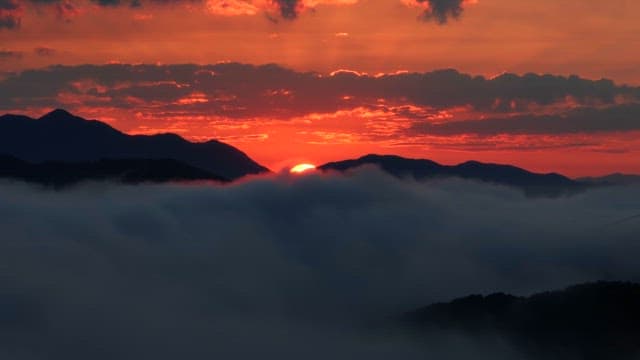 Sunset over mountains with clouds