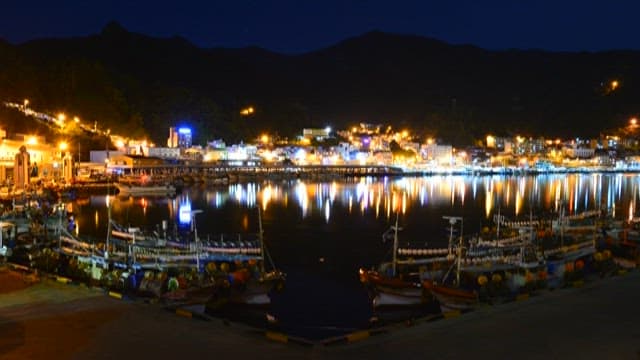 Port with fishing boats anchored near a coastal village