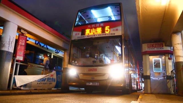 Bus Leaving with Passengers at Night