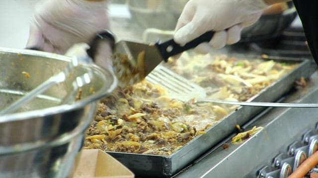 Cooking Korean beef bulgogi on a hot grill