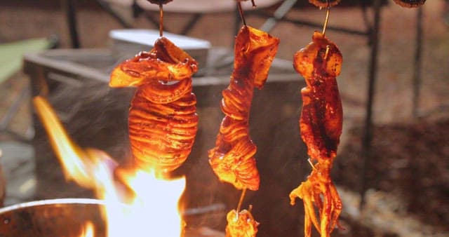 Sizzling squid being cooked on a grill