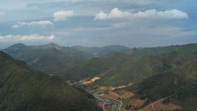 Vast mountainous terrain and blue sky with clouds