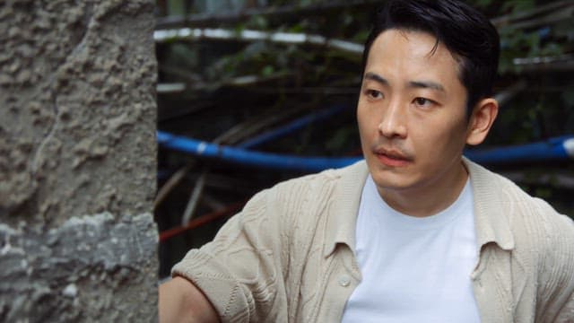 Man peeking from behind the corner