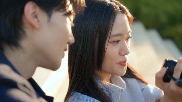 Couple checking videos with camcorders in the park