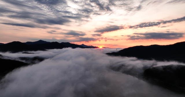 Sunrise over misty mountains