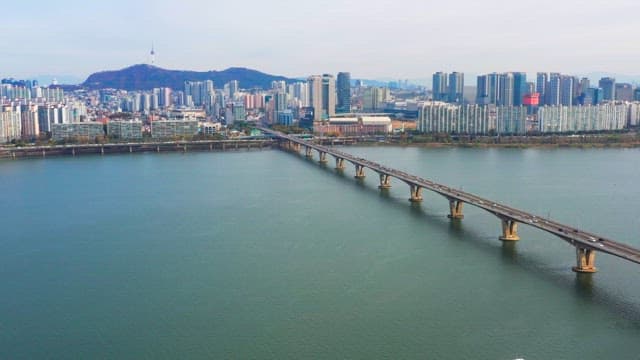 Bridge over a river with city skyline