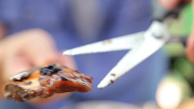 Grilled Meat Close-Up with Tongs