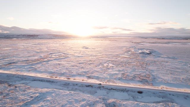 Snowy landscape with a road at sunrise