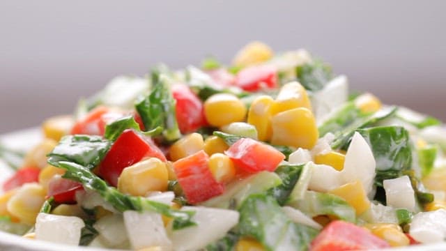 Fresh vegetable salad with corn, peppers and spring cabbage