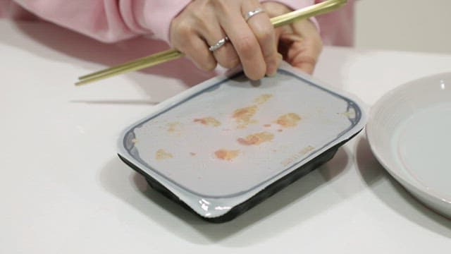 Opening a ready meal package with chicken feet