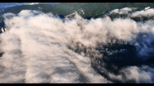 Cityscape with clouds over mountains