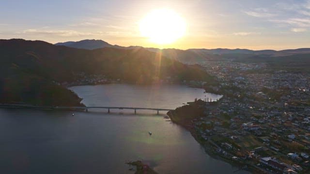 Sunrise over a lake with a bridge