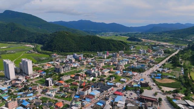Small town surrounded by lush mountains