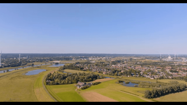 Aerial view of a village surrounded by fields and trees