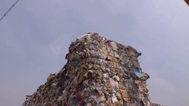 Recycling center with piles of compressed recyclable paper
