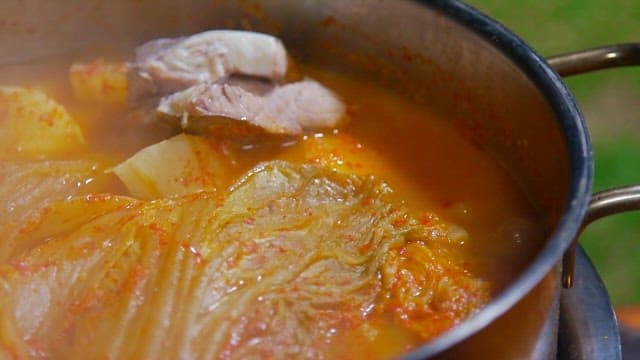Kimchi stew with tofu and fish in a pot