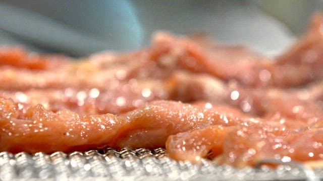 Grilling marinated pork ribs on a charcoal grill