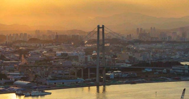 Busy scenery of Ulsan Bridge and industrial complex from dusk to night