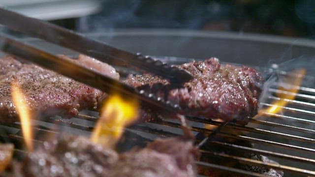 Grilling juicy steaks over open flames