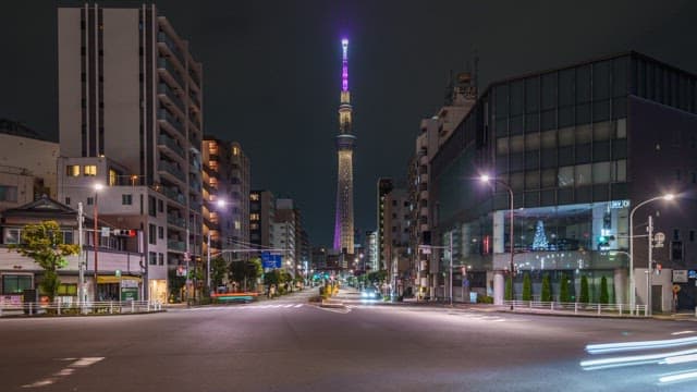 City street with illuminated tower at night