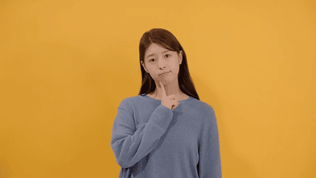 Woman lost in thought, resting her finger on her chin