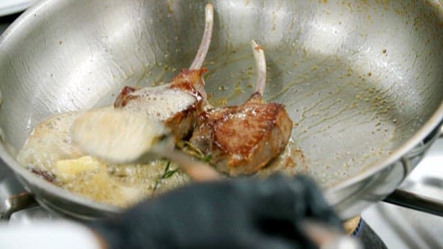 Gourmet Chef Preparing Rack of Lamb with Caviar
