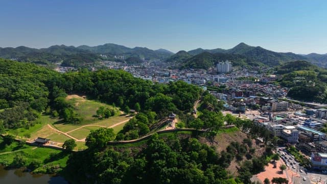 Beautiful city surrounded by lush green hills