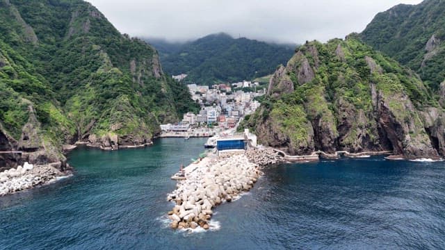 Coastal town surrounded by lush mountains