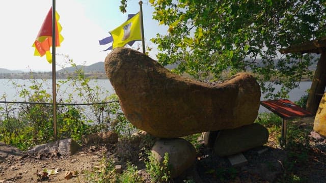 Rock tower surrounded by trees and greenery