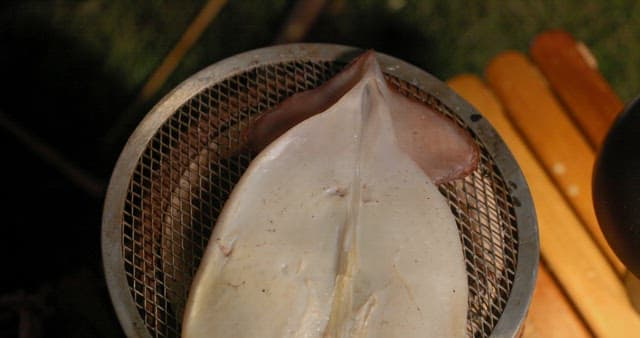 Preparing Squid on a Grill Outdoors