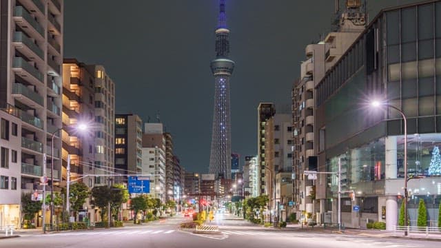Night view of a city street with a tower