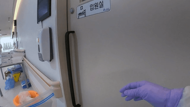Medical Staff Wearing Suits for Quarantine and Entering a Patient's Room