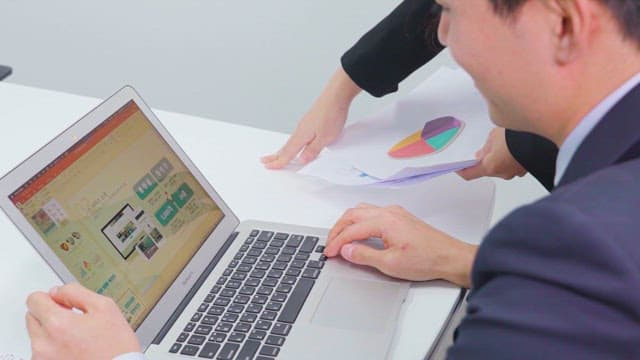 Business Professionals Reviewing Digital Data