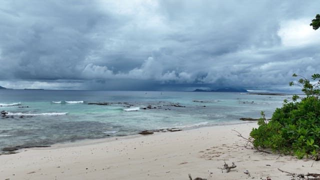 Serene beach with waves and cloudy sky
