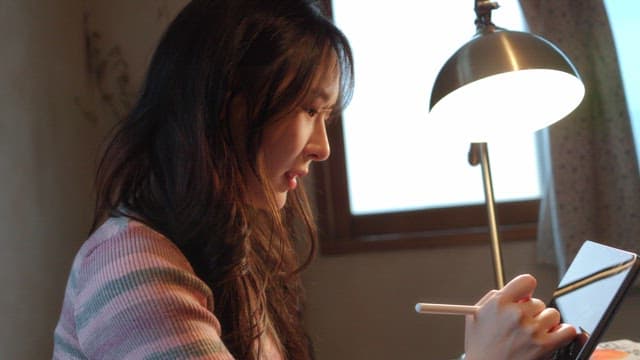 Woman studying with a tablet indoors