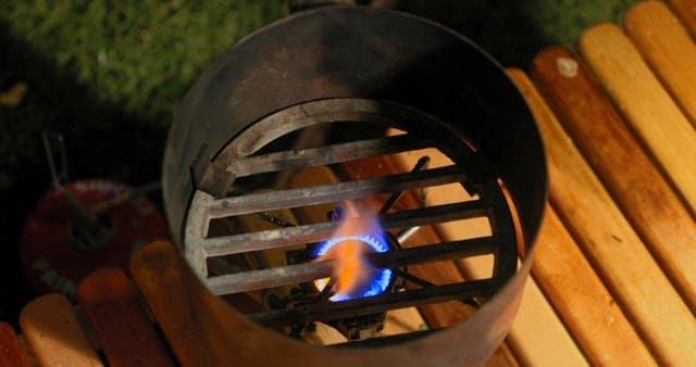 Igniting Charcoal in a Grill at Night