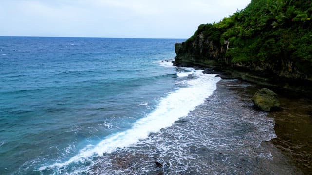 Serene Coastal Cliff with Waves Crashing