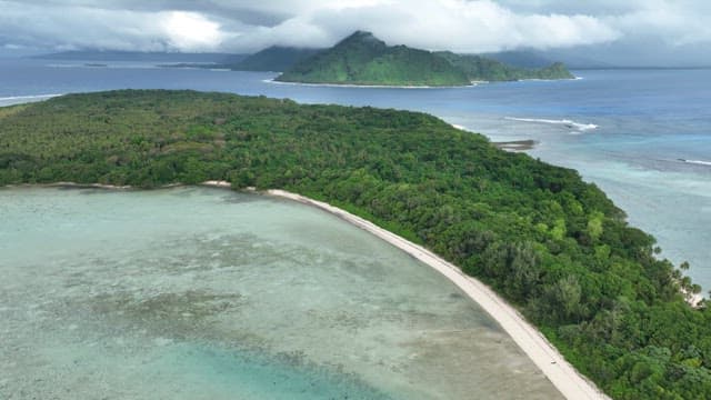 Blue beach on an island with lush rainforests