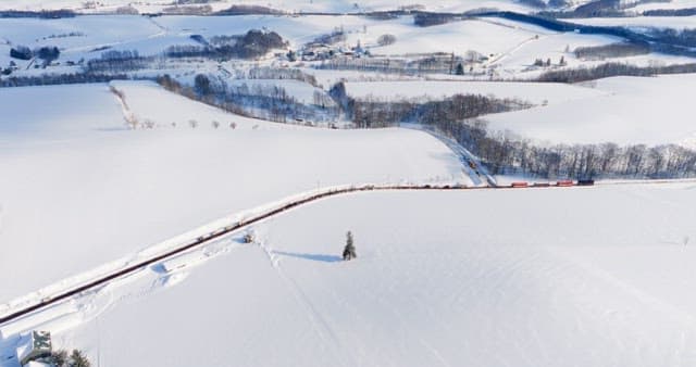 Winter Train Journey Through Snowy Landscape