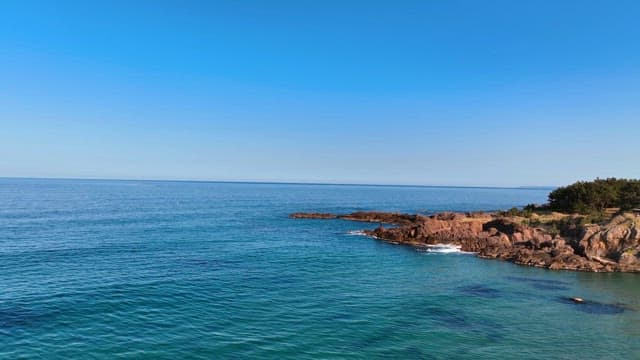 Coastal landscape with clear blue sea
