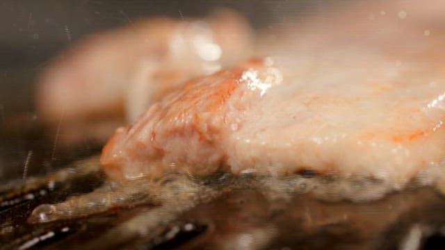 Sizzling pork belly on a hot grill