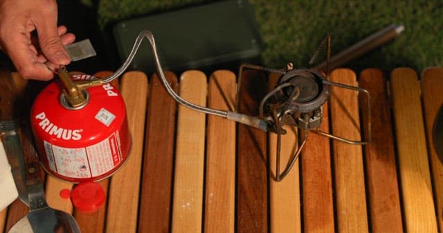 Igniting a portable camping stove outdoors