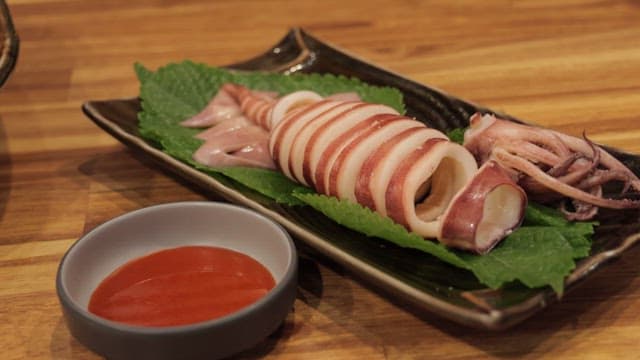 Delicious steamed squid dipped in red chili-pepper paste with vinegar