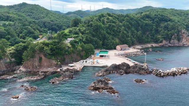 Coastal village with lush green hills